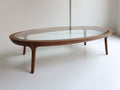 Couchtisch aus Klarglas und Holz 140×75×40 cm - Transparent/Walnussbraun - geschwungener Ovalrahmen